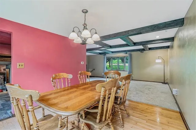 a view of a dining room with furniture and chandelier