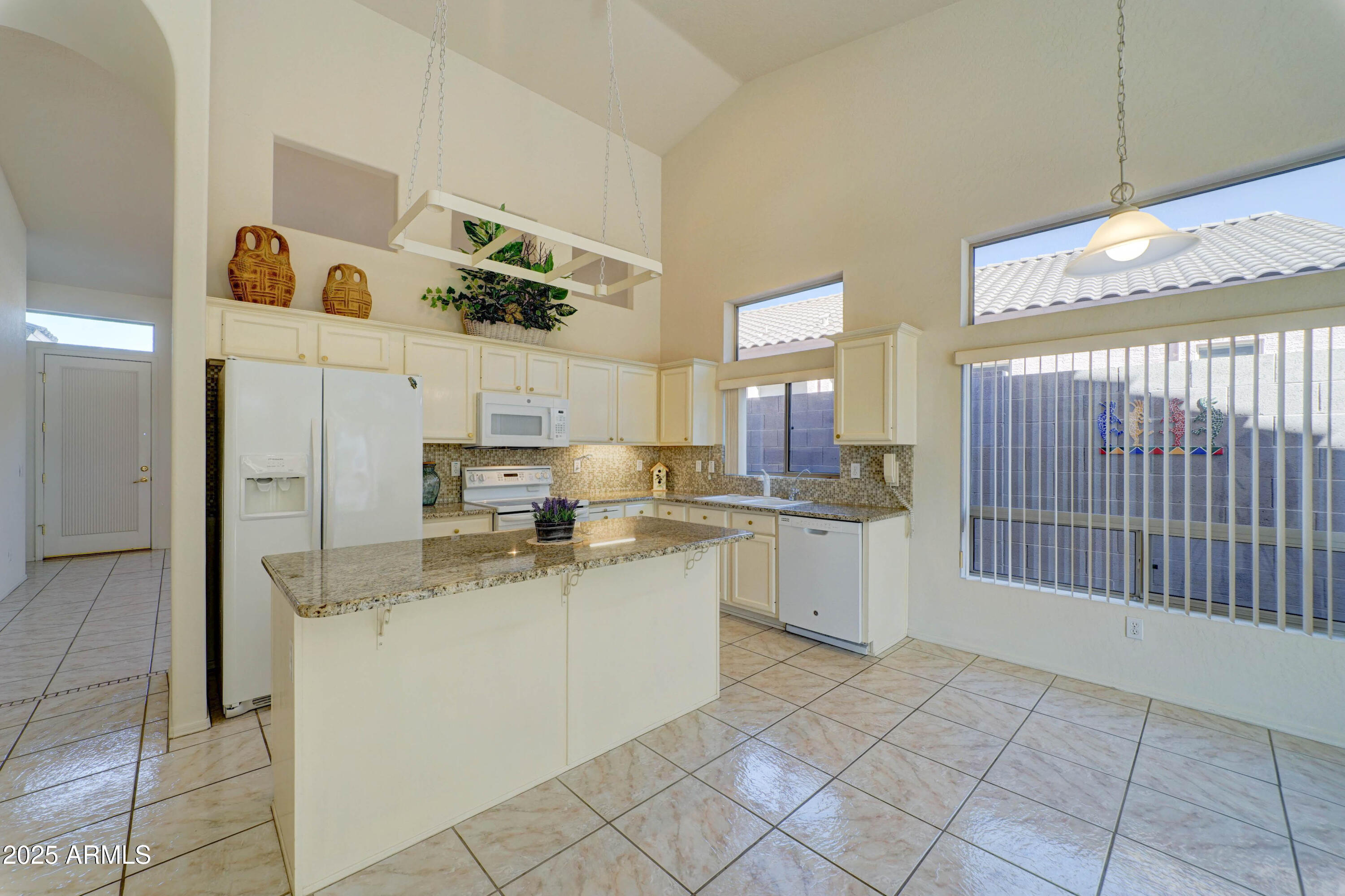 3055 North Red Mountain, Unit 74 Mesa, AZ 85207 - Photo 15 of 38 a kitchen with a sink and cabinets