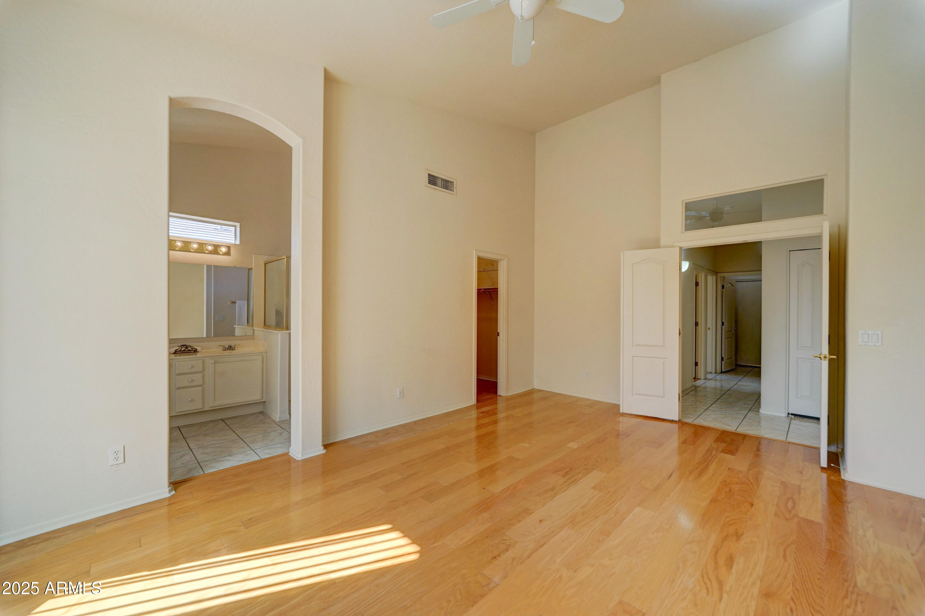 3055 North Red Mountain, Unit 74 Mesa, AZ 85207 - Photo 20 of 38 a view of an empty room with wooden floor
