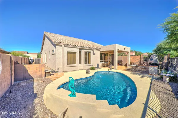a view of a house with swimming pool and sitting area