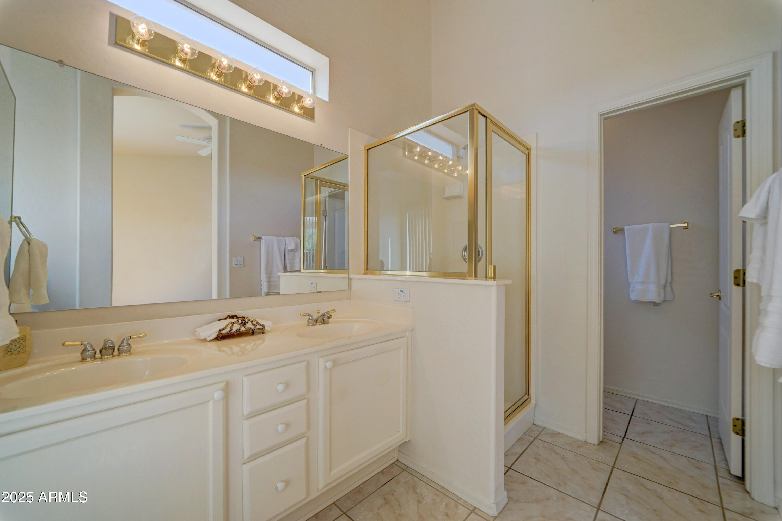 3055 North Red Mountain, Unit 74 Mesa, AZ 85207 - Photo 24 of 38 a bathroom with a shower sink and mirror