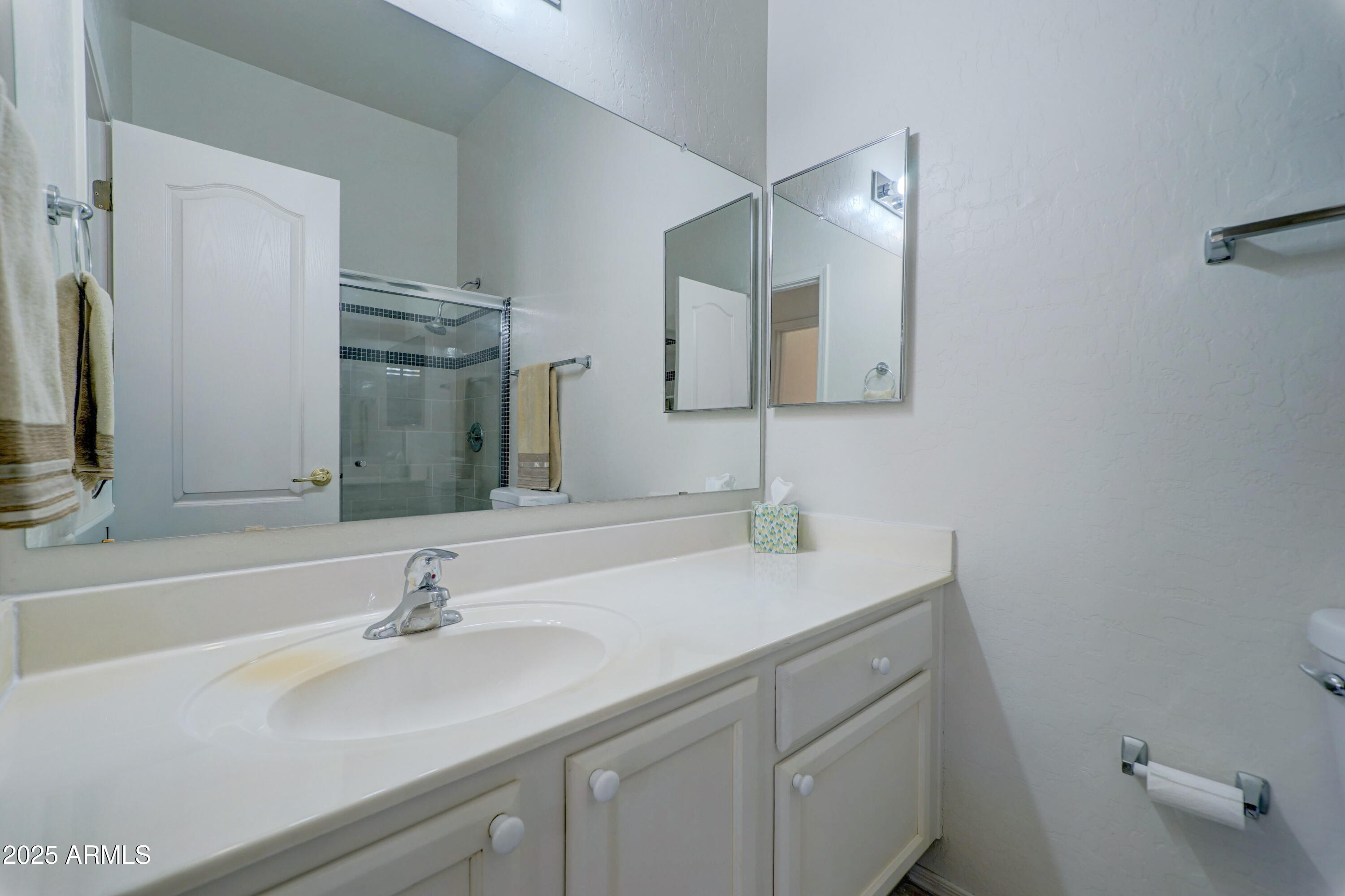 3055 North Red Mountain, Unit 74 Mesa, AZ 85207 - Photo 32 of 38 a bathroom with a sink and a mirror