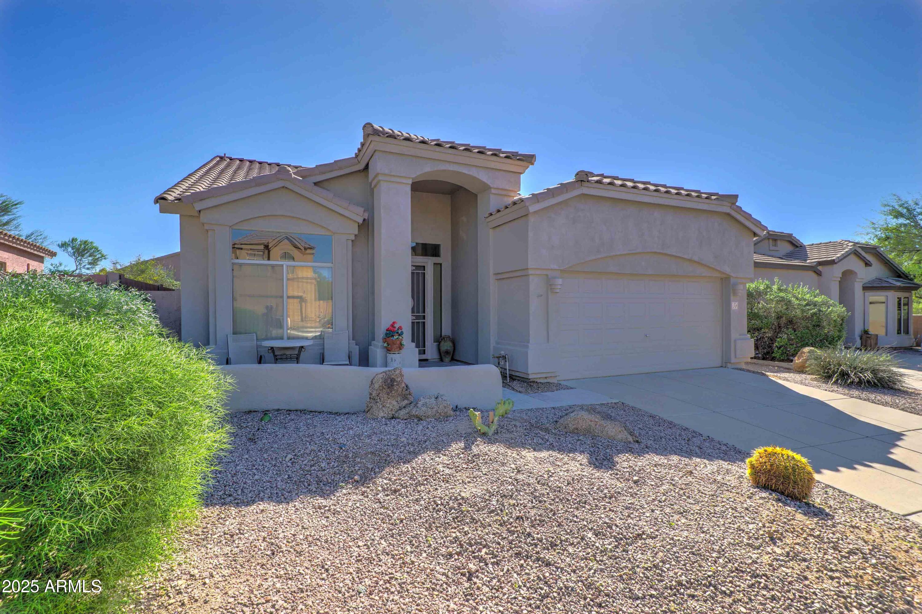3055 North Red Mountain, Unit 74 Mesa, AZ 85207 - Photo 6 of 38 a front view of a house with a yard