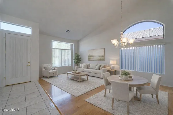 a living room with furniture a table and a chandelier