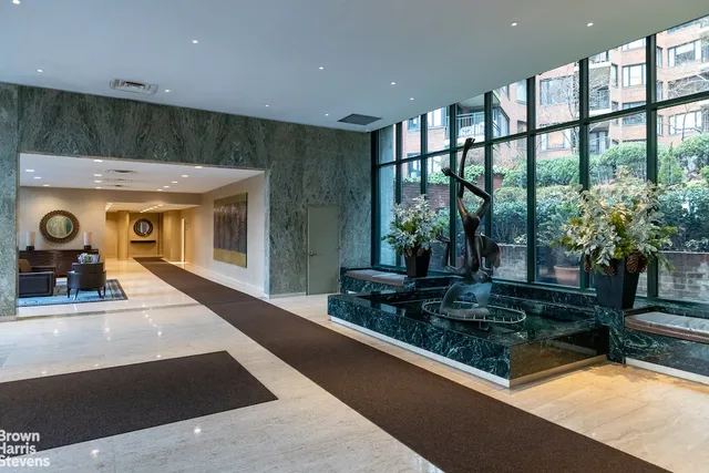 a lobby with furniture and a potted plant