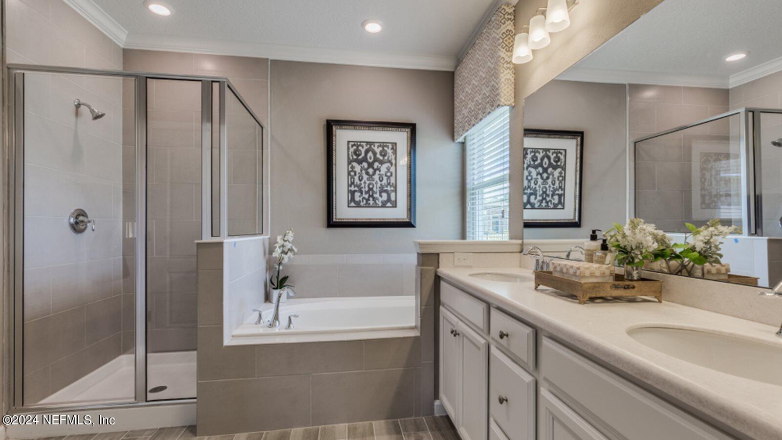 49 Blue Cypress Trail St. Augustine, FL 32084 - Photo 17 of 23 a bathroom with double vanity sinks a shower and a mirror