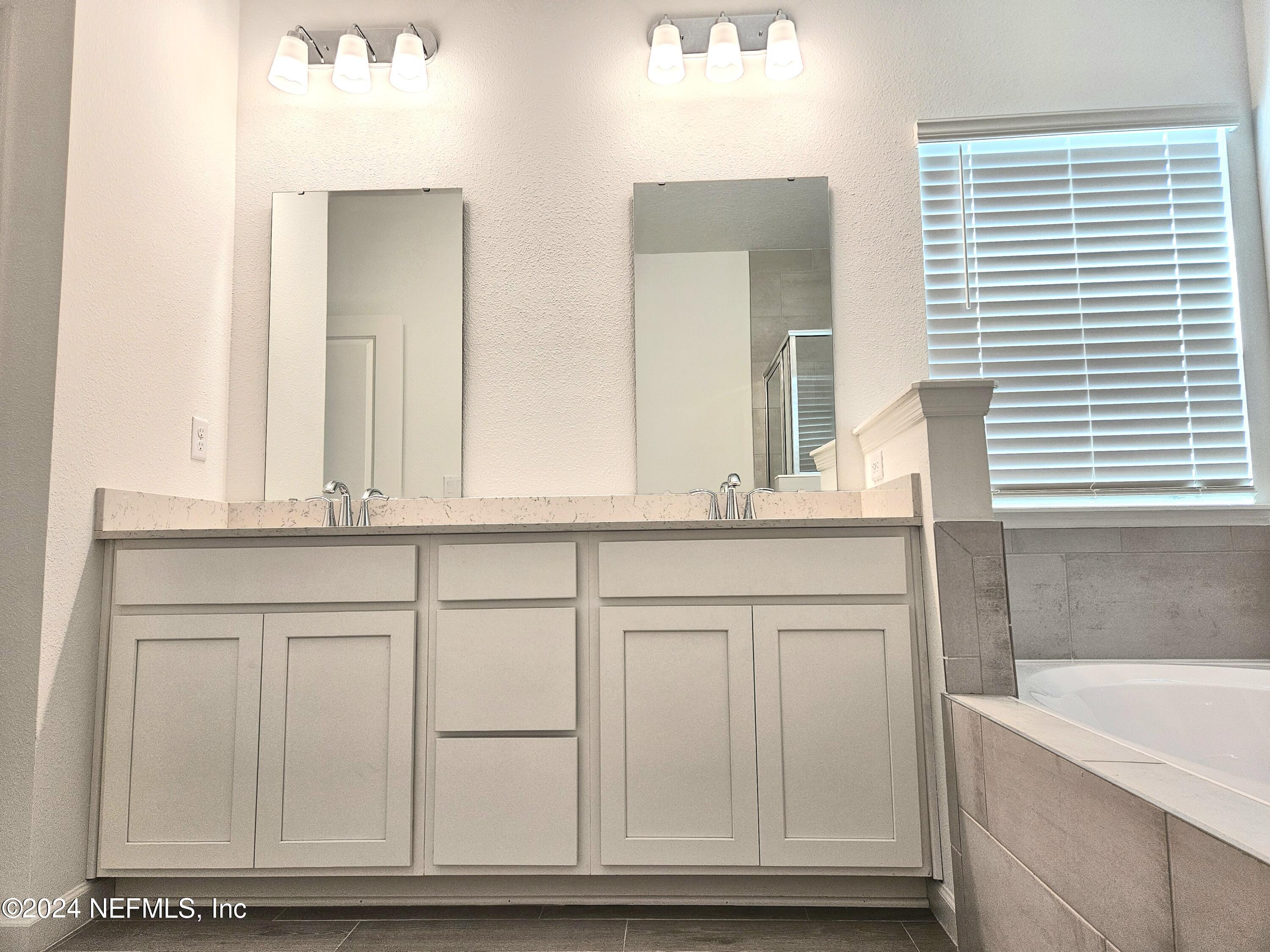 49 Blue Cypress Trail St. Augustine, FL 32084 - Photo 18 of 23 a bathroom with a sink and a mirror