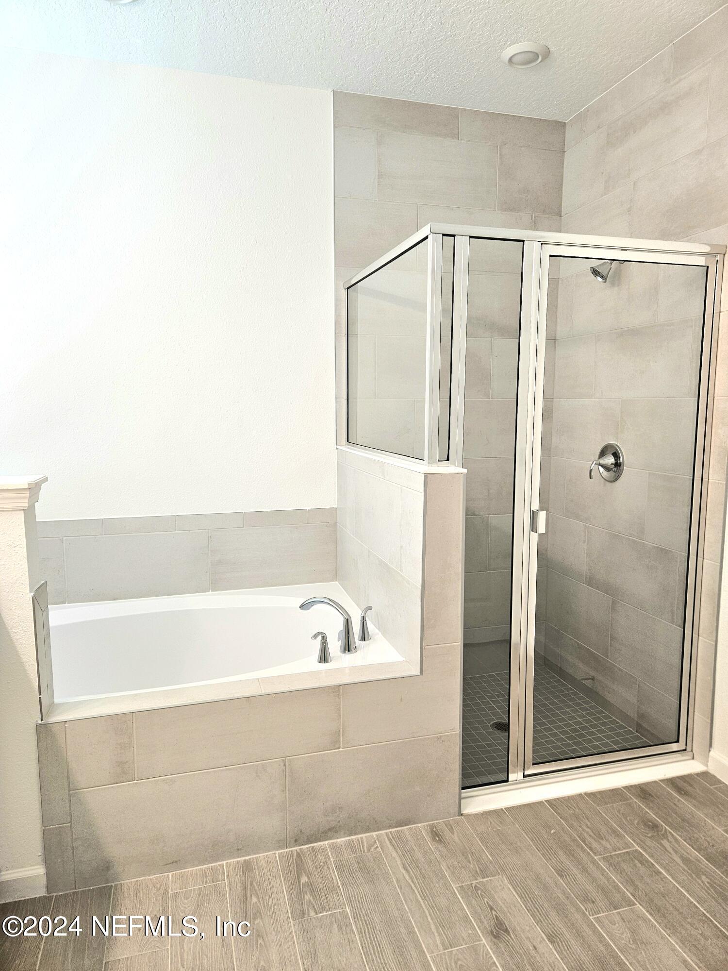 49 Blue Cypress Trail St. Augustine, FL 32084 - Photo 19 of 23 a bathroom with a bathtub and a shower