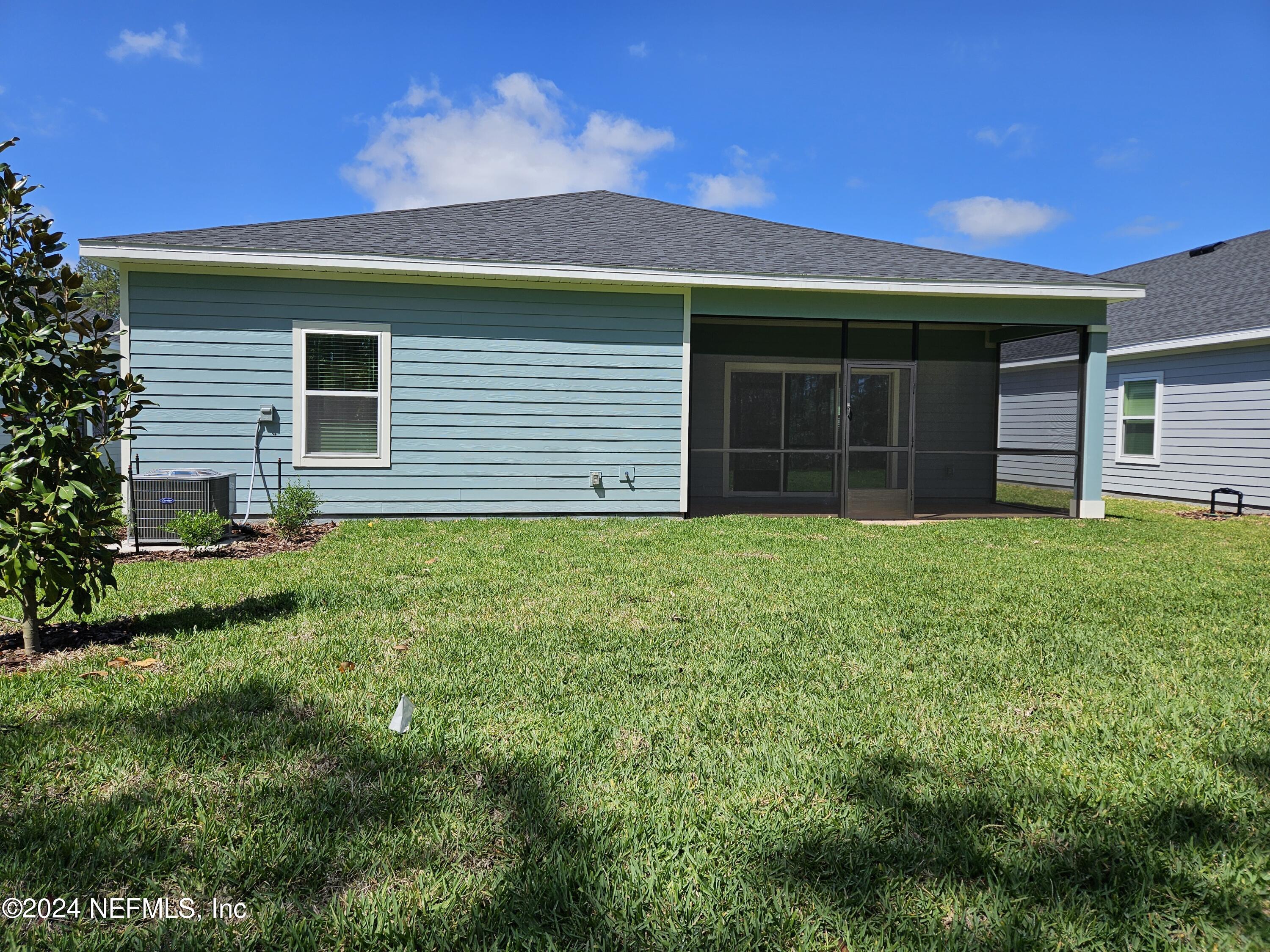 49 Blue Cypress Trail St. Augustine, FL 32084 - Photo 22 of 23 a house with green field in front of it