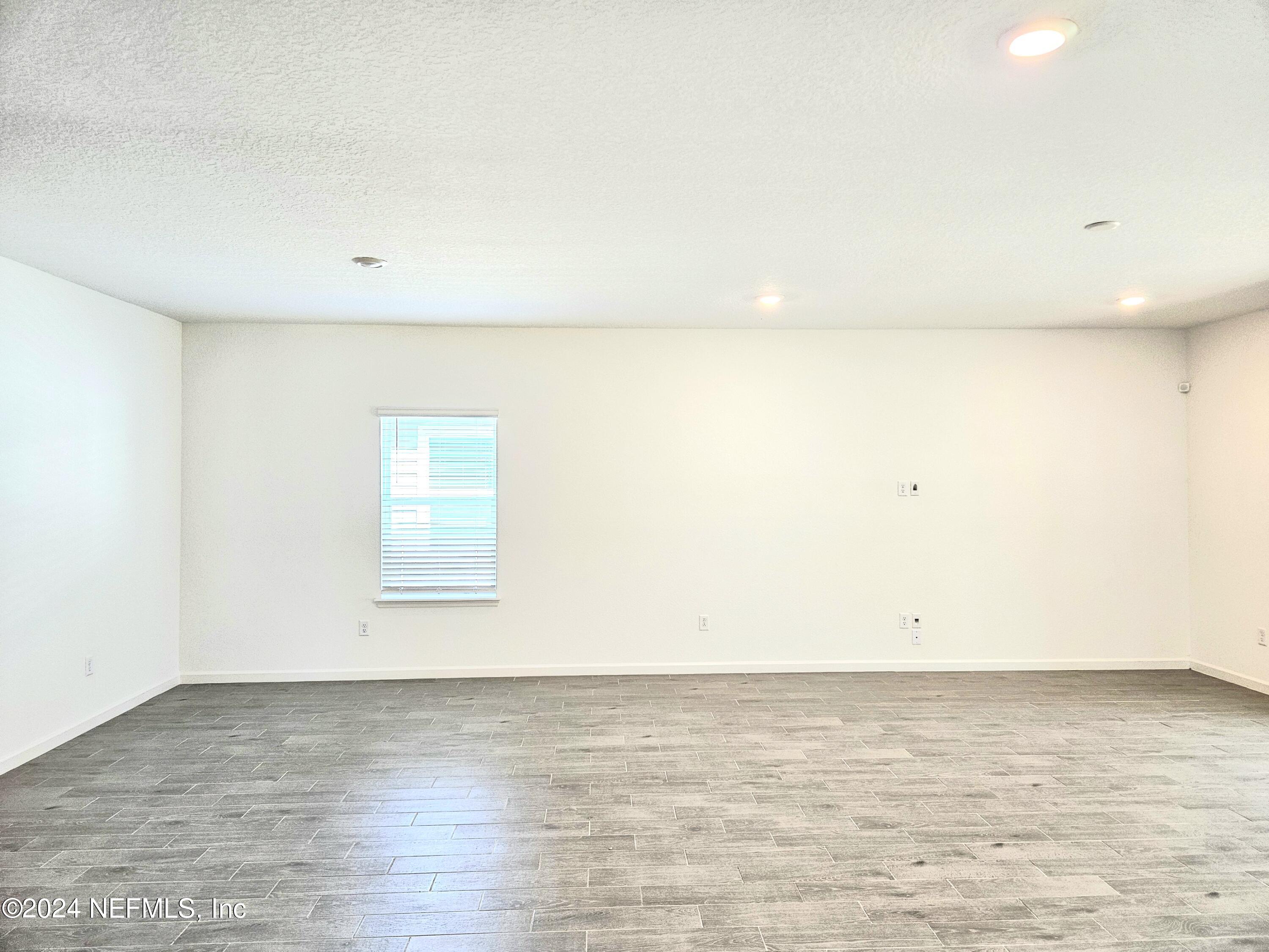 49 Blue Cypress Trail St. Augustine, FL 32084 - Photo 10 of 23 an empty room with a natural light