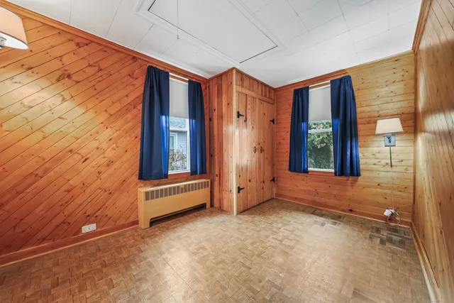 a view of a house with wooden fence
