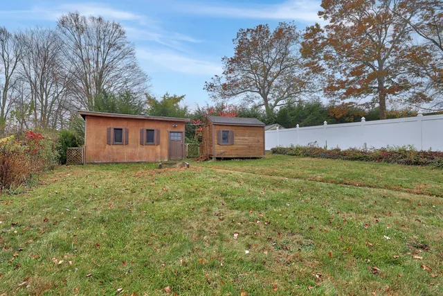 a view of a house with a yard and deck