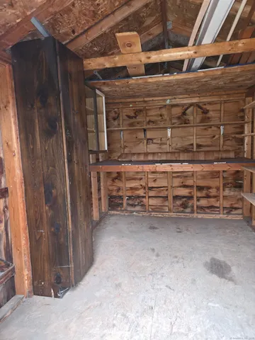 a room with water heater and wooden racks