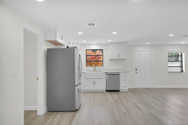 a kitchen with stainless steel appliances a stove microwave and sink