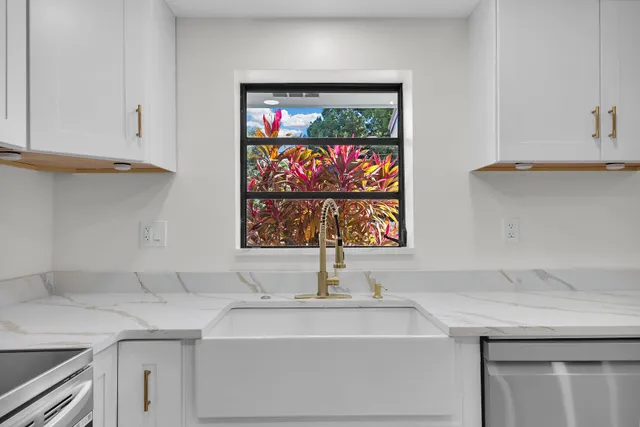 an empty room with wooden floor ceiling fan and windows