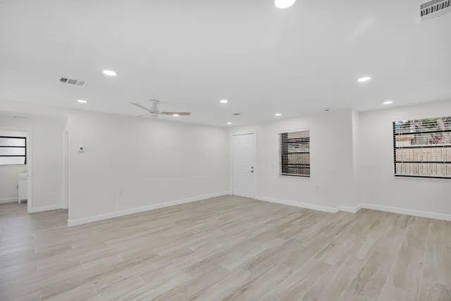 wooden floor in an empty room with a window