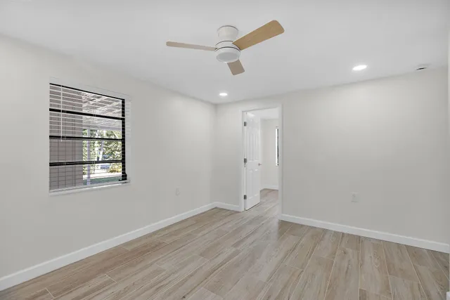 wooden floor in an empty room with a window