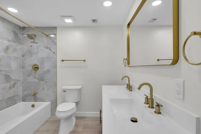 a bathroom with a sink vanity and a mirror