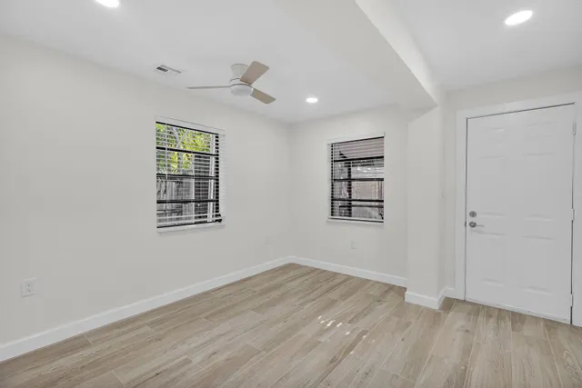 wooden floor in an empty room with a window