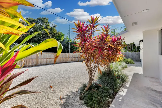 a view of kitchen with a sink wooden cabinet and a refrigerator