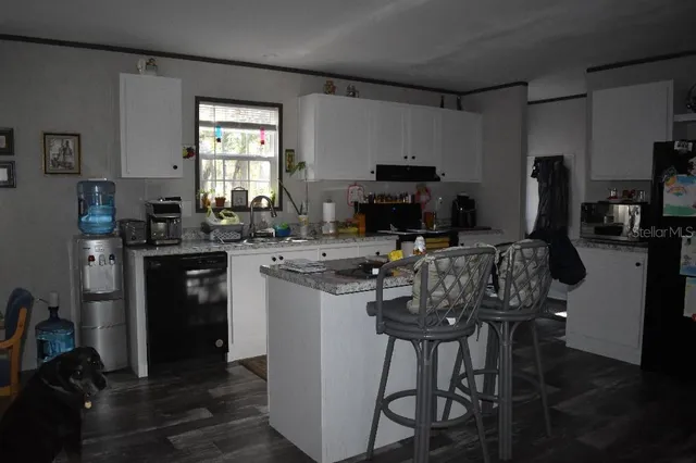 a view of a dining room with furniture and window