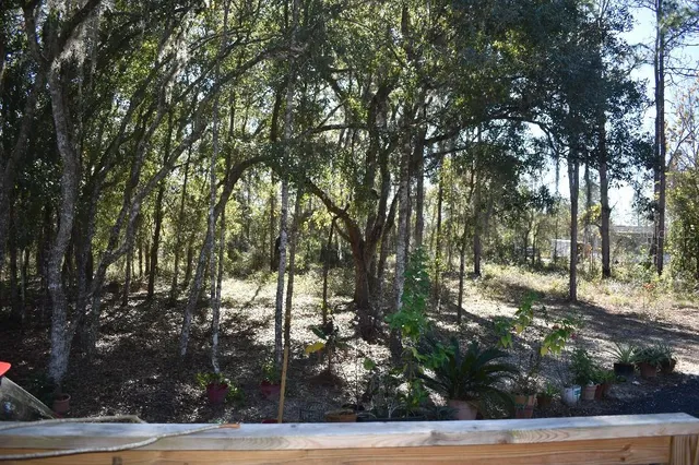 a view of a house with swimming pool and a yard