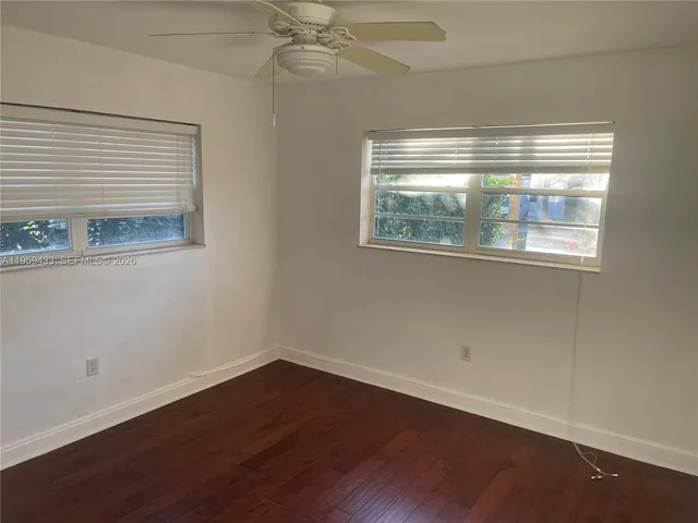 a view of room with window and wooden floor