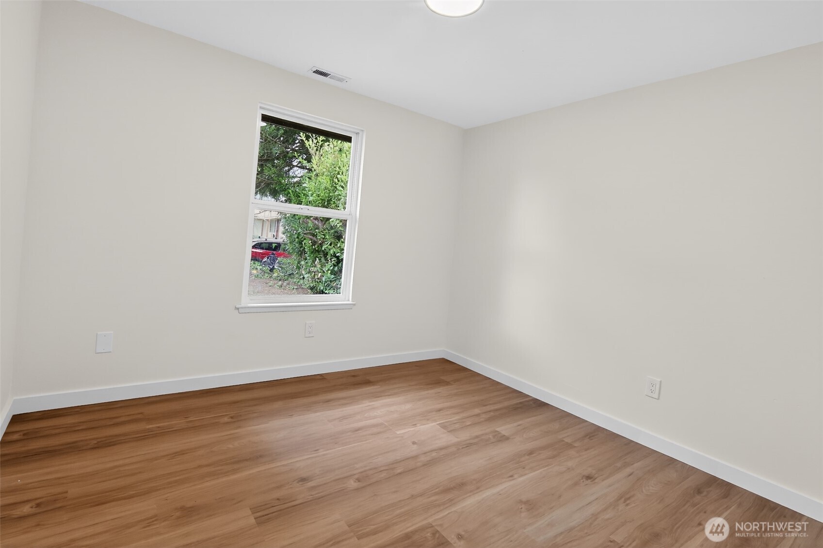 320 213th Place Southwest Bothell, WA 98021 - Photo 14 of 29 wooden floor in an empty room with a window