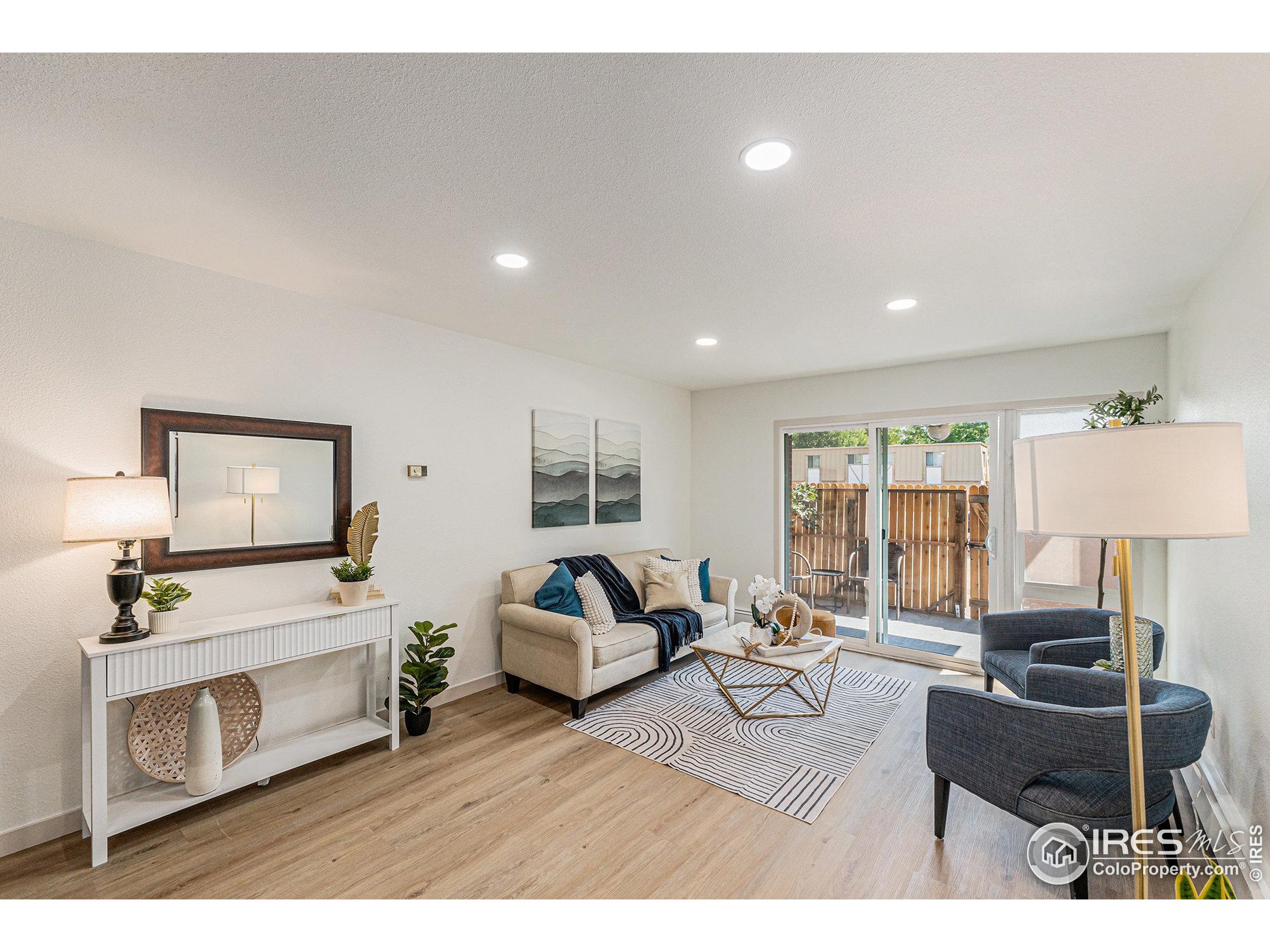 620 Mathews Street, Unit 104 Fort Collins, CO 80524 - Photo 1 of 32 a living room with furniture and a fireplace