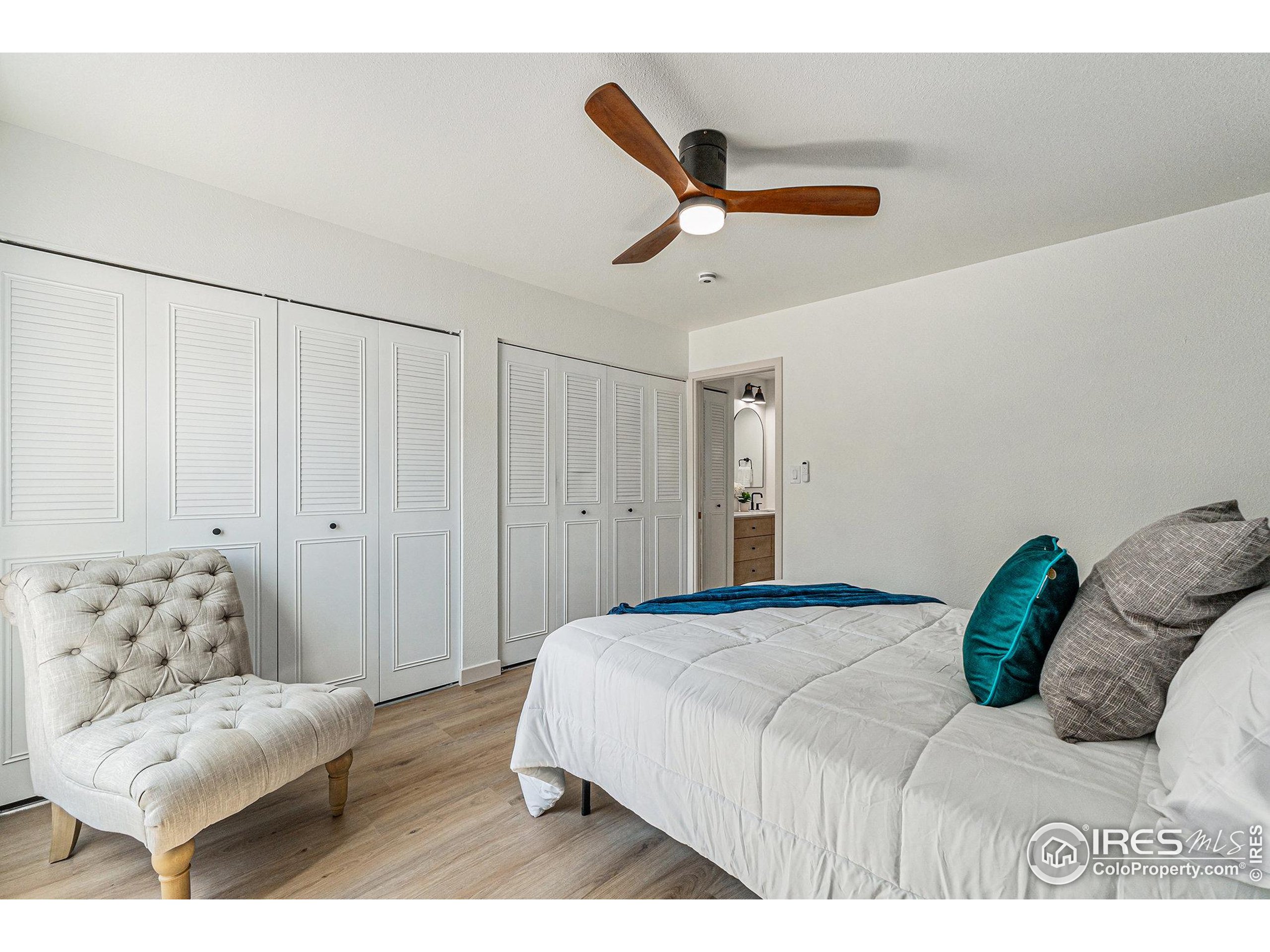 620 Mathews Street, Unit 104 Fort Collins, CO 80524 - Photo 11 of 32 a bedroom with a bed and ceiling fan