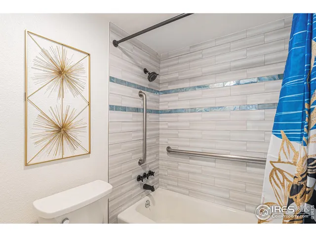 a bathroom with a sink a toilet and a shower