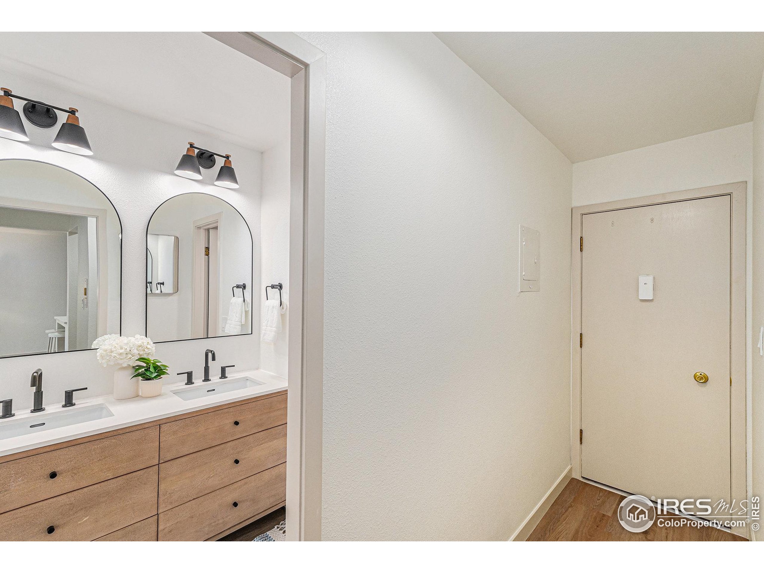 620 Mathews Street, Unit 104 Fort Collins, CO 80524 - Photo 19 of 32 a bathroom with a double vanity sink and mirror with shower