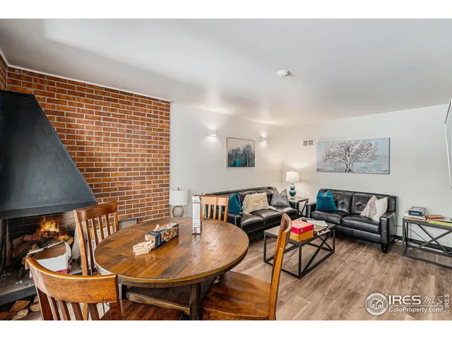 a living room with furniture and a lamp