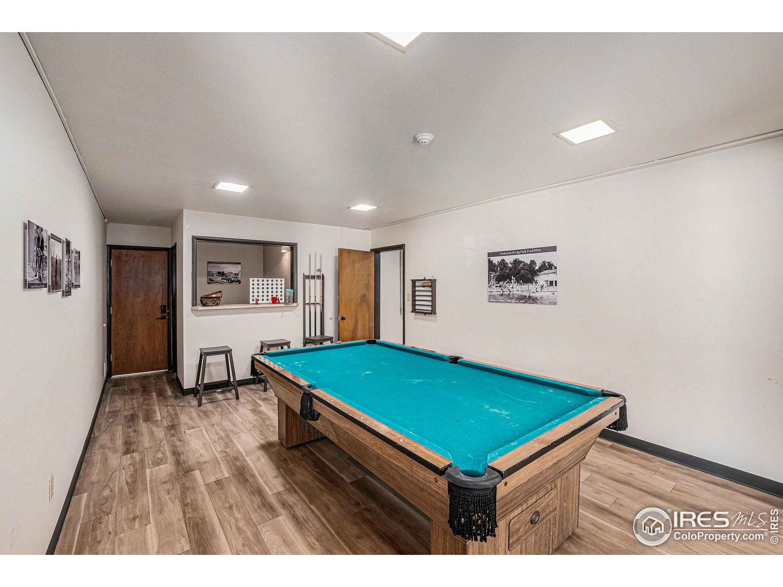 620 Mathews Street, Unit 104 Fort Collins, CO 80524 - Photo 26 of 32 a room with pool table and paintings on the wall