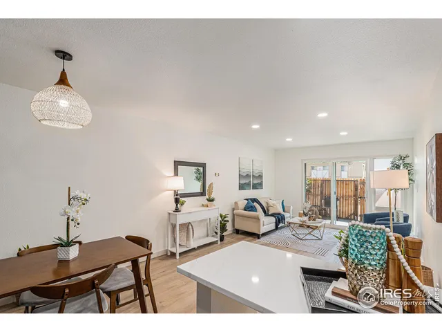 a living room with kitchen island furniture and a chandelier