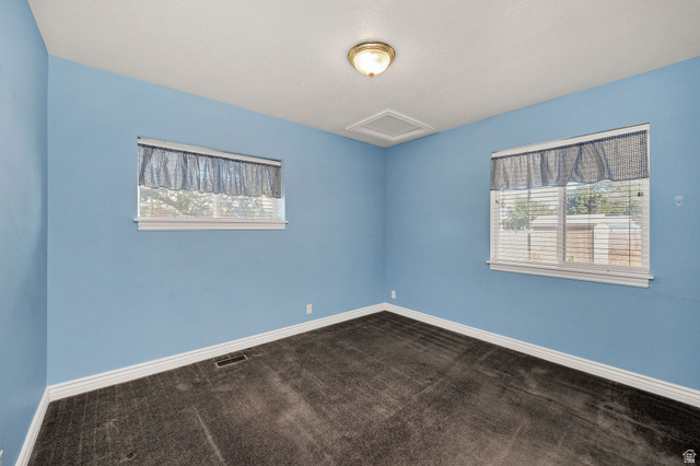 80 North 500 West Logan, UT 84321 - Photo 13 of 36 Room featuring two windows, neutral carpet, and a ceiling-mounted light fixture