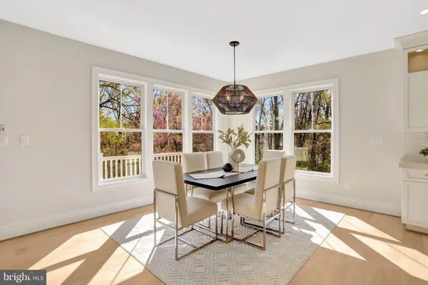 a view of a dining room with furniture large windows and wooden floor