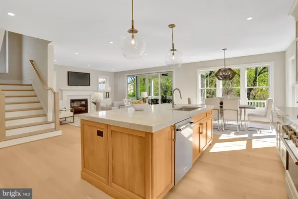 a kitchen with a stove a sink and a window