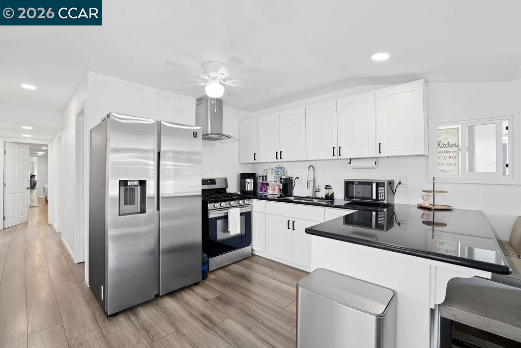 a kitchen with stainless steel appliances a refrigerator sink and stove
