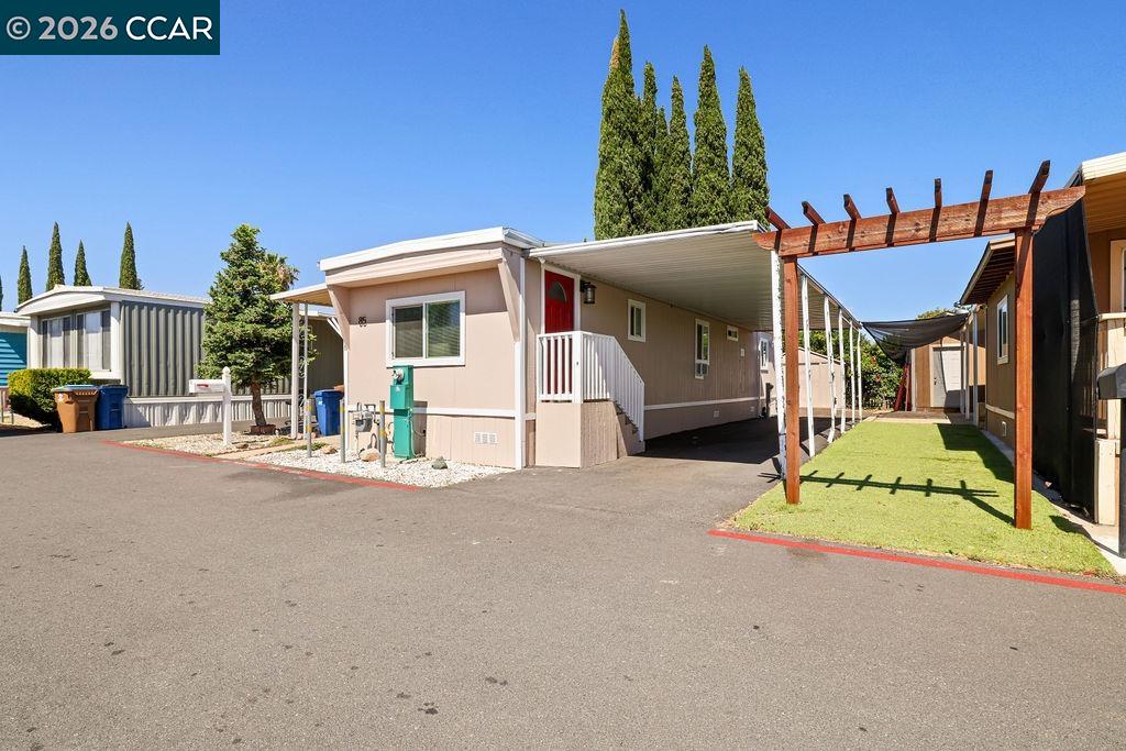 3301 Buchanan Road, Unit 85 Antioch, CA 94509 - Photo 15 of 26 a front view of a house with a yard and outdoor seating