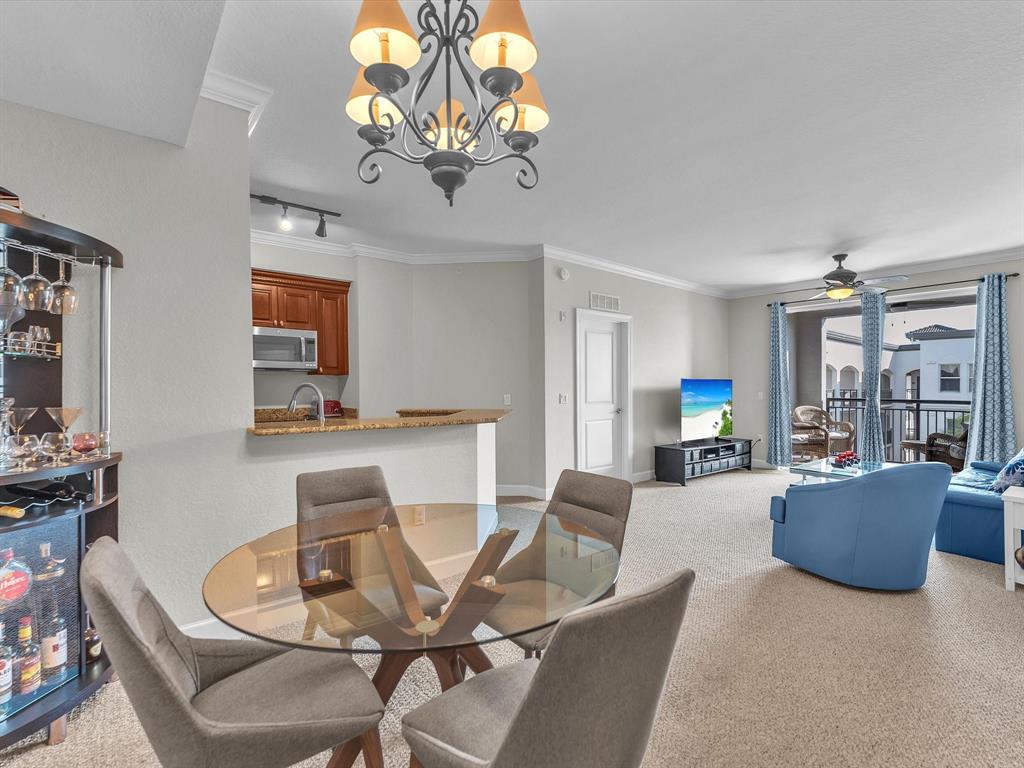 1660 Renaissance Commons Boulevard, Unit 2628 Boynton Beach, FL 33426 - Photo 19 of 49 a view of a dining room with furniture wooden floor and chandelier