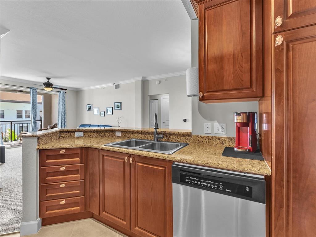 1660 Renaissance Commons Boulevard, Unit 2628 Boynton Beach, FL 33426 - Photo 23 of 49 a kitchen with stainless steel appliances granite countertop a sink and cabinets