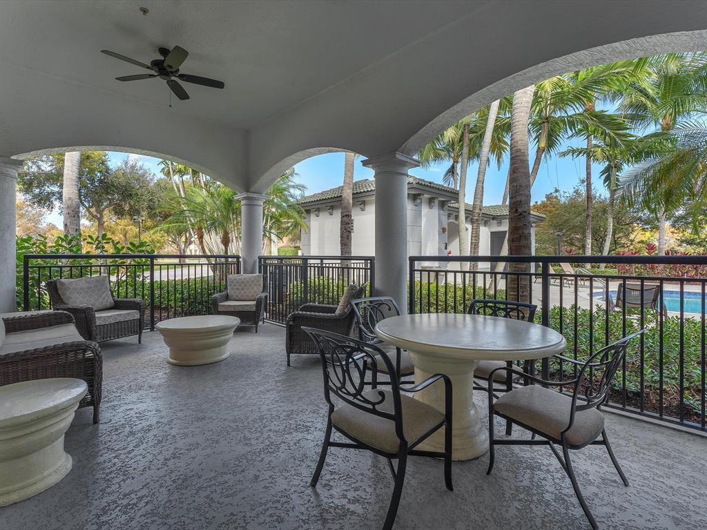 1660 Renaissance Commons Boulevard, Unit 2628 Boynton Beach, FL 33426 - Photo 35 of 49 a dining room with furniture and a garden