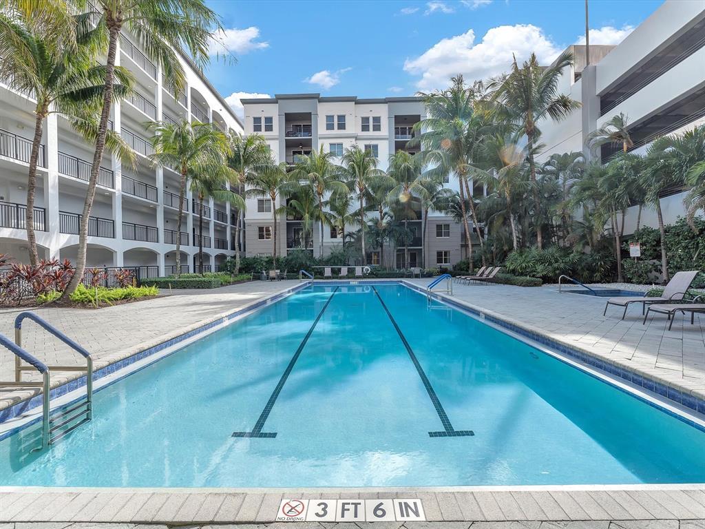 1660 Renaissance Commons Boulevard, Unit 2628 Boynton Beach, FL 33426 - Photo 41 of 49 a swimming pool with outdoor seating and yard