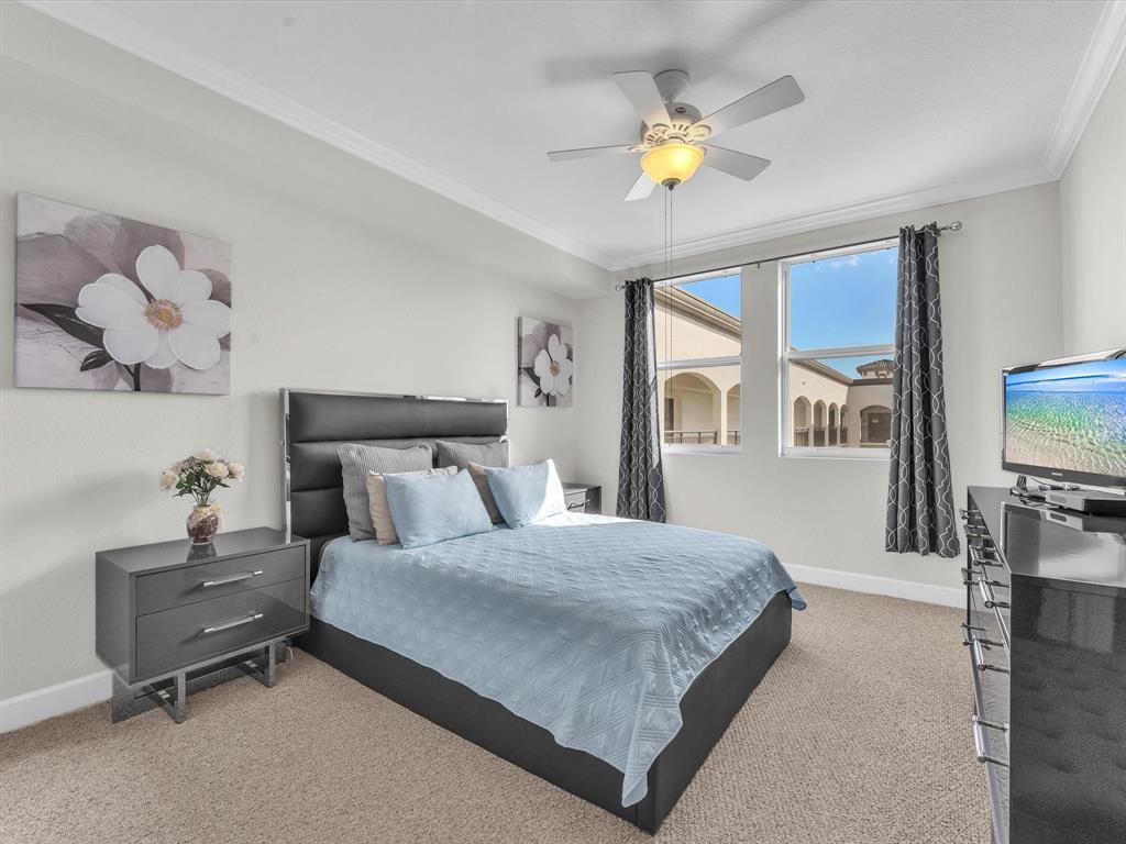 1660 Renaissance Commons Boulevard, Unit 2628 Boynton Beach, FL 33426 - Photo 6 of 49 a bedroom with a bed a mirror on dresser and a chandelier