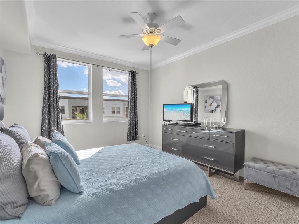 1660 Renaissance Commons Boulevard, Unit 2628 Boynton Beach, FL 33426 - Photo 7 of 49 a bedroom with a bed and a chandelier fan