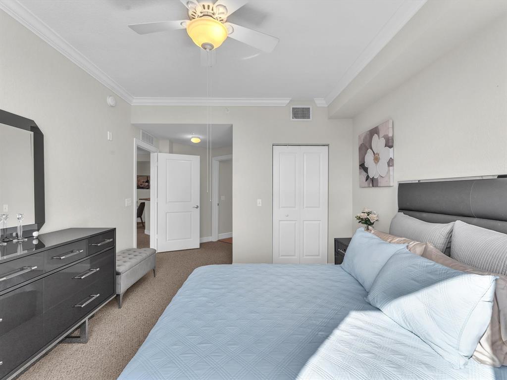 1660 Renaissance Commons Boulevard, Unit 2628 Boynton Beach, FL 33426 - Photo 8 of 49 a spacious bedroom with a bed and a chandelier
