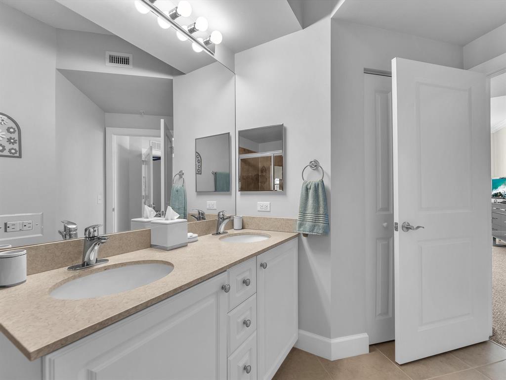 1660 Renaissance Commons Boulevard, Unit 2628 Boynton Beach, FL 33426 - Photo 9 of 49 a bathroom with a granite countertop sink double and mirror