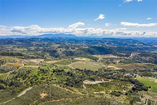 an aerial view of residential houses with city view