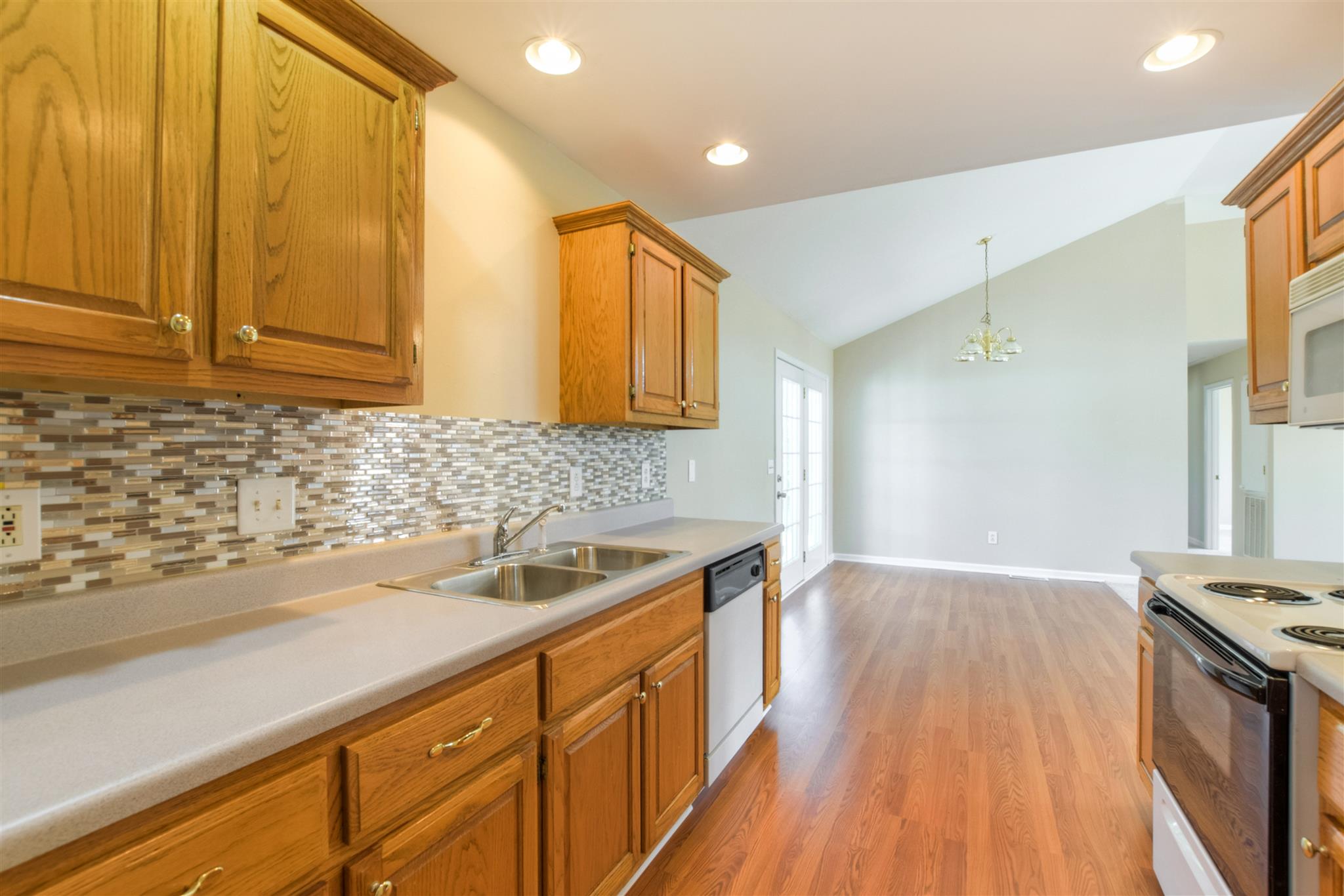 516 Windy Road Mount Juliet, TN 37122 - Photo 11 of 30 a kitchen with a sink and wooden cabinets